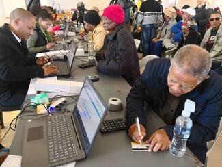Older Persons grant clients receive new cards at Post Office