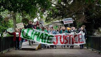 Members of climate Change organisation holding up banner