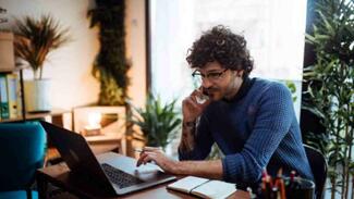A freelance worker working from his laptop