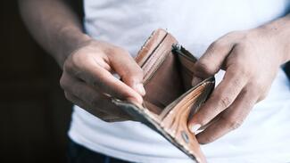 Man holding empty wallet 