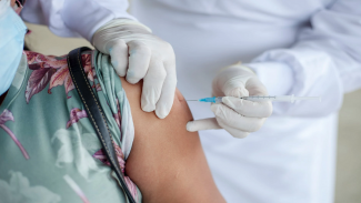 person receiving Covid-19 vaccine injection